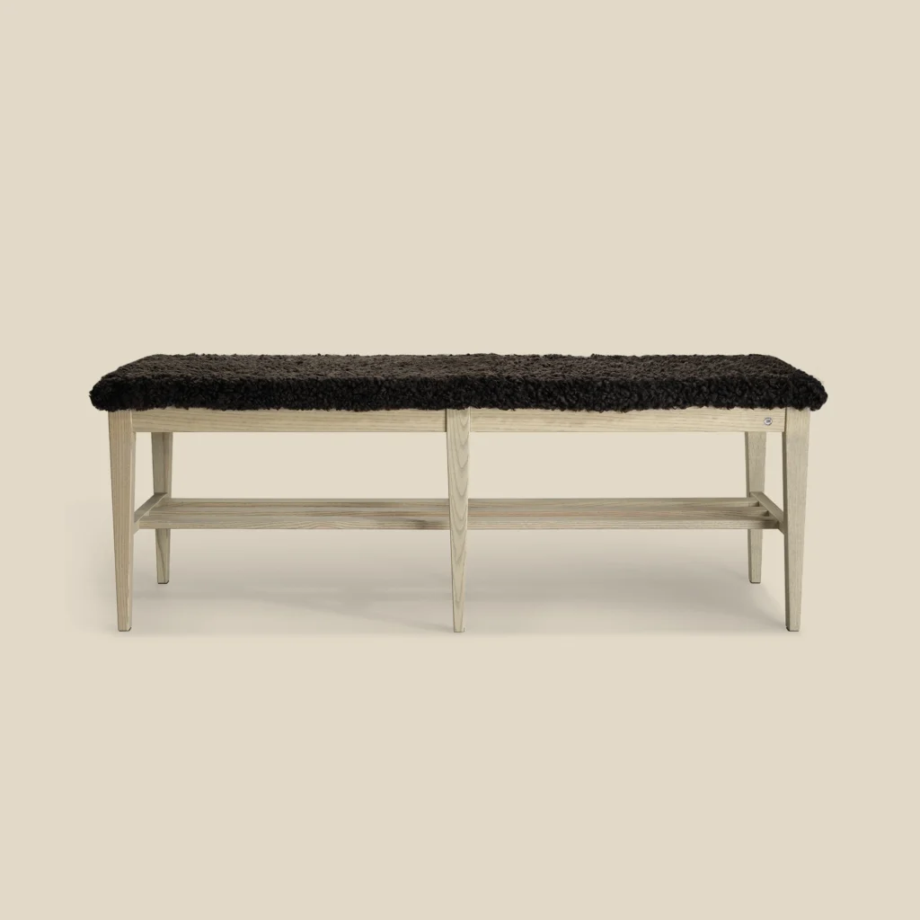 Nadja bench 130 in grey oiled ash with brown sheepskin on beige background