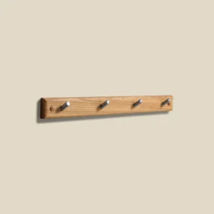 Meja hook rail in oiled oak with polished steel L49 on beige background